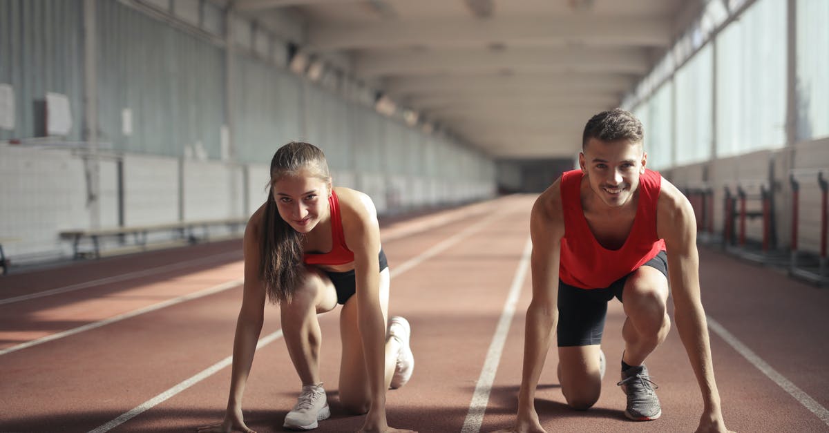 Change or swap fit skills damage with others - Men and Woman in Red Tank Top is Ready to Run on Track Field Change or swap fit skills damage with others - Men and Woman in Red Tank Top is Ready to Run on Track Field
