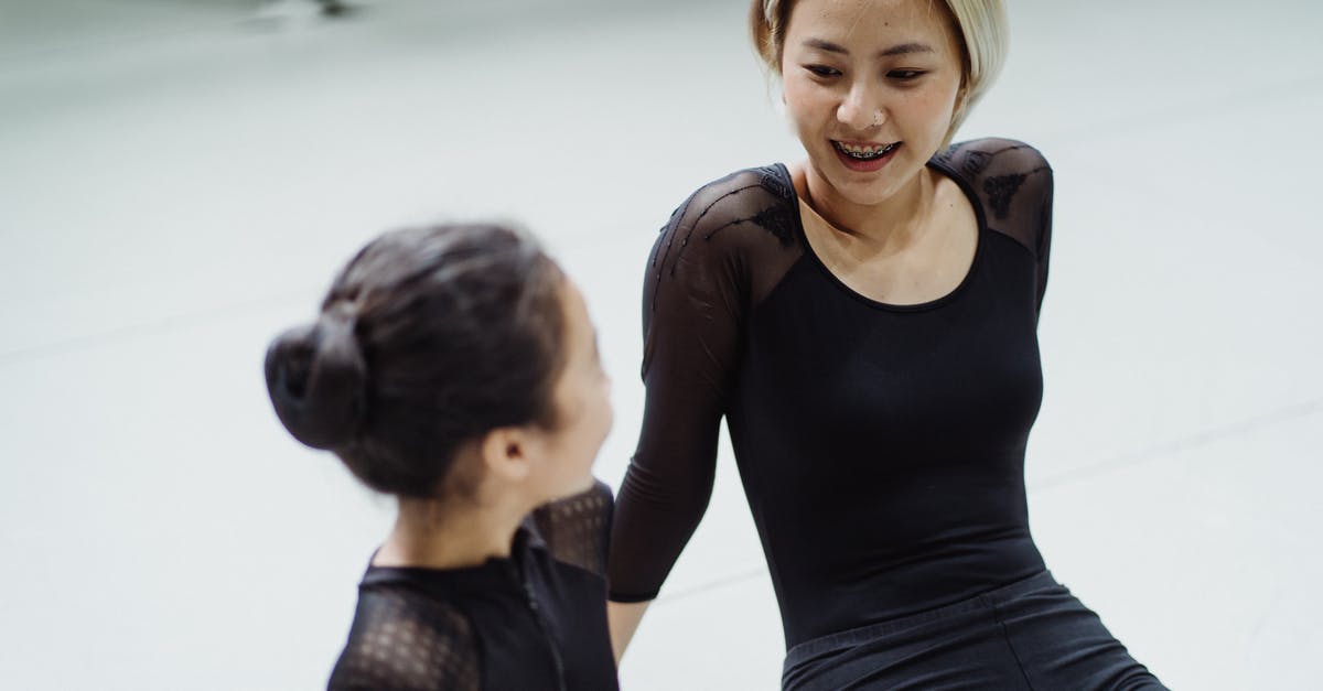 Change or swap fit skills damage with others - Content fit female ballet dancer and girl in leotards sitting on floor in ballet school and discussing movement techniques Change or swap fit skills damage with others - Content fit female ballet dancer and girl in leotards sitting on floor in ballet school and discussing movement techniques