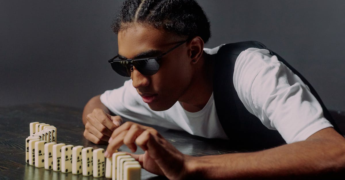 Change selected side in Taking Sides quest [duplicate] - Man taking one of the domino blocks from a side view