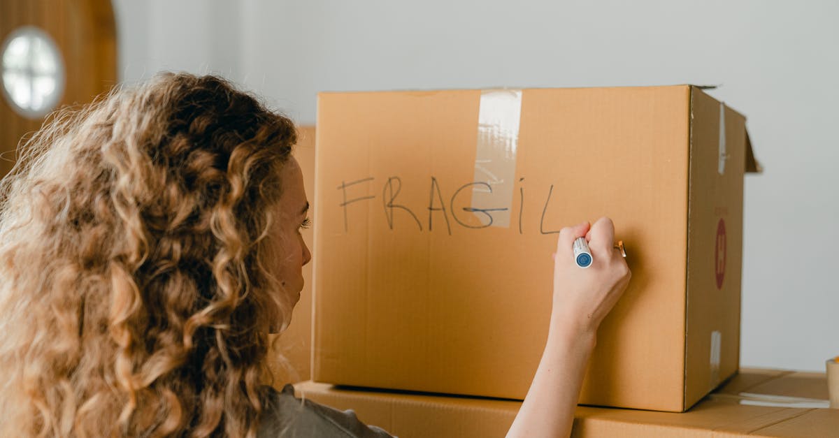 Change selected side in Taking Sides quest [duplicate] - Back view of unrecognizable curvy female in casual clothes writing fragile on empty side of carton box while waiting for courier