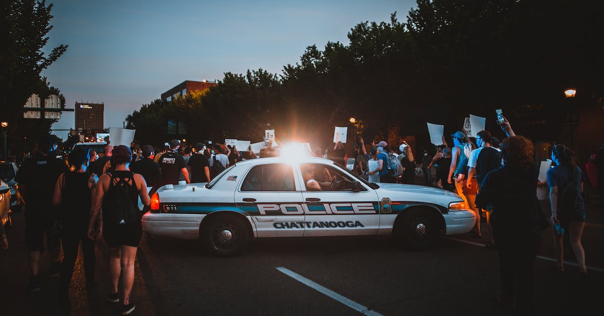 Changes in NBTExplorer do not change world - Police car with lamp on roof among group of protesters with posters and banners at night Changes in NBTExplorer do not change world - Police car with lamp on roof among group of protesters with posters and banners at night