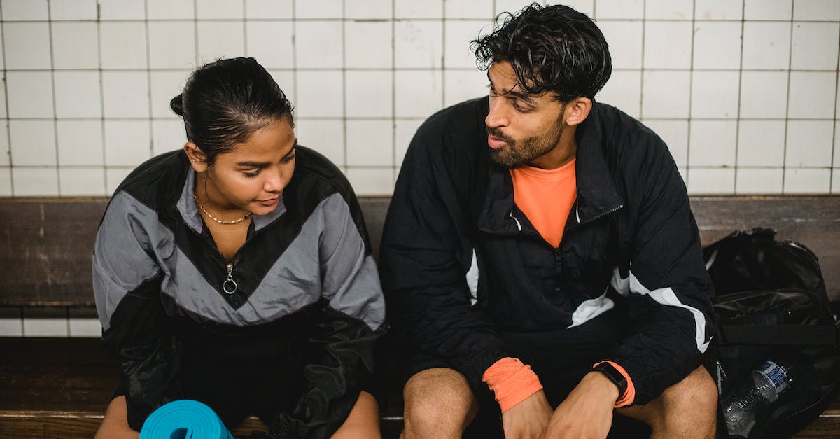 Changing Paragon Portraits - Two Young Sport People Resting after Fitness Exercises in Changing Room