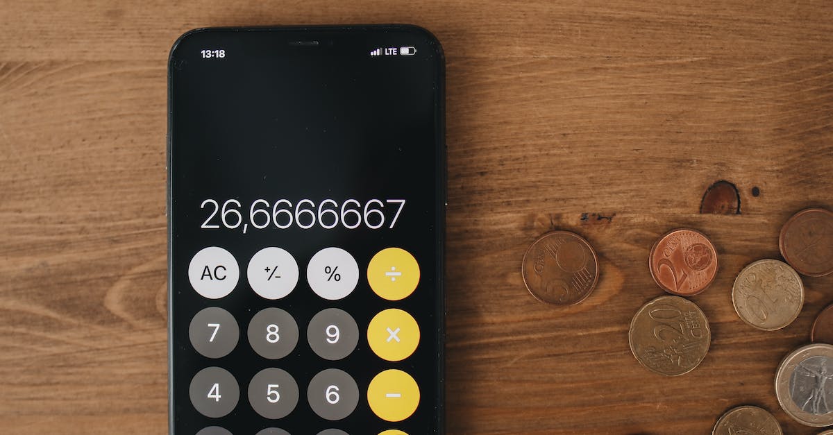 Changing screen in Skyrim? - Close Up View of Loose Change and Calculator On Wooden Surface