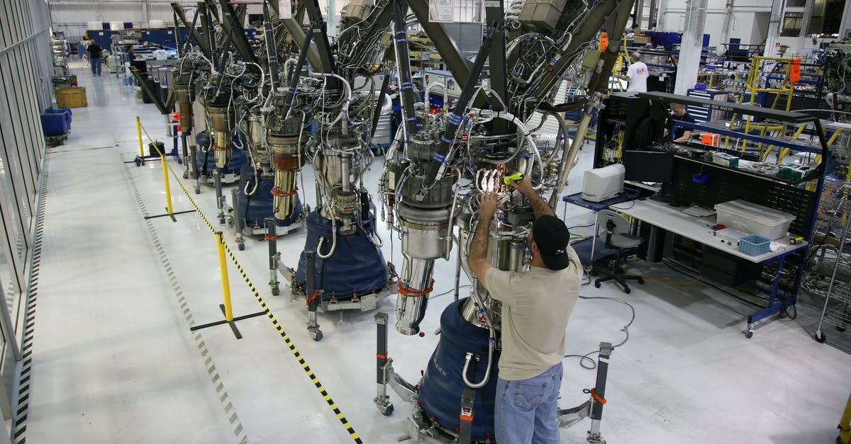 Check download progress while away - Anonymous mechanic fixing rocket details during assembly