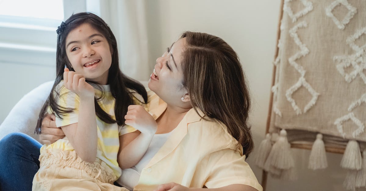 Children happiness factor - A Mother and Her Daughter Smiling Together Children happiness factor - A Mother and Her Daughter Smiling Together