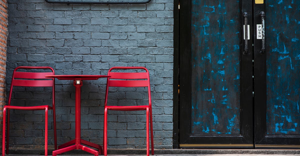 Cities still occupied by ally - Red Chairs and Coffee Table Standing at Blue Door to Cafeteria