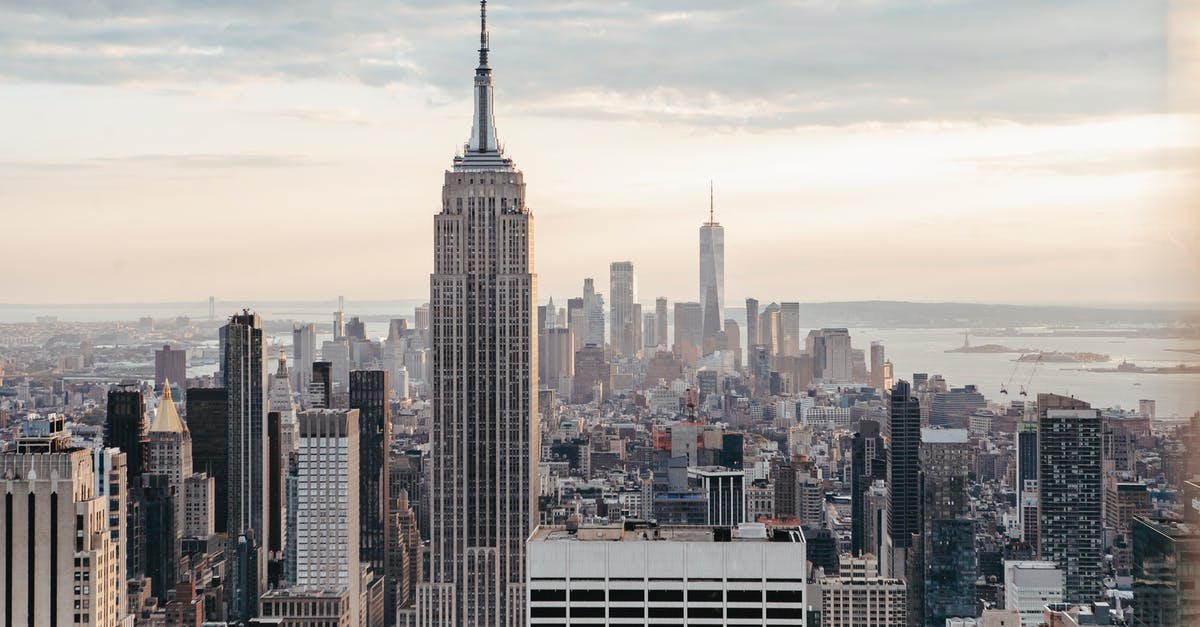 City State Empire? - Empire State Building near multistage houses against ocean