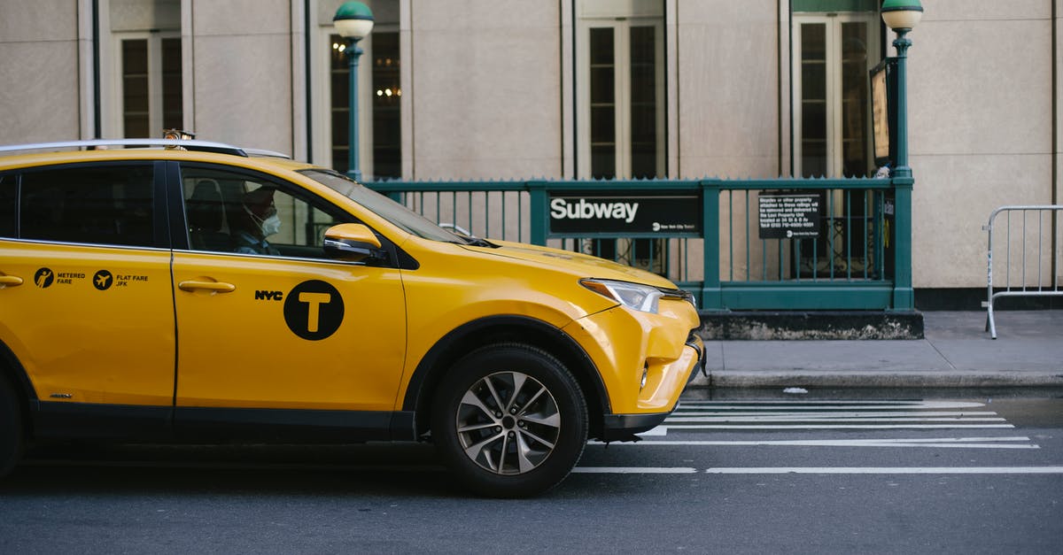 Civ 5 - how to protect city states? - Contemporary yellow taxi with driver in medical mask standing on empty road near modern building and subway station entrance during coronavirus pandemic in New York USA