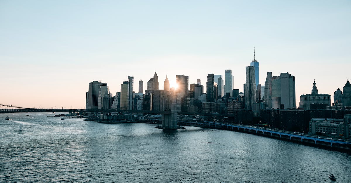 Civ 5 BNW: why are city states far tougher than major civ cities on settler? - View from over sea on bridge and skyscrapers behind it