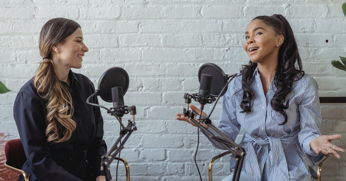 CKII - Aquitaine, Hugh's Host - Smiling African American female guest gesticulating while having interview with journalist sitting near mic