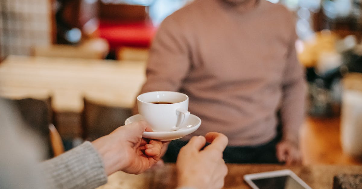 Clash of Clans: Take a break - Crop couple having breakfast together with coffee at home Clash of Clans: Take a break - Crop couple having breakfast together with coffee at home