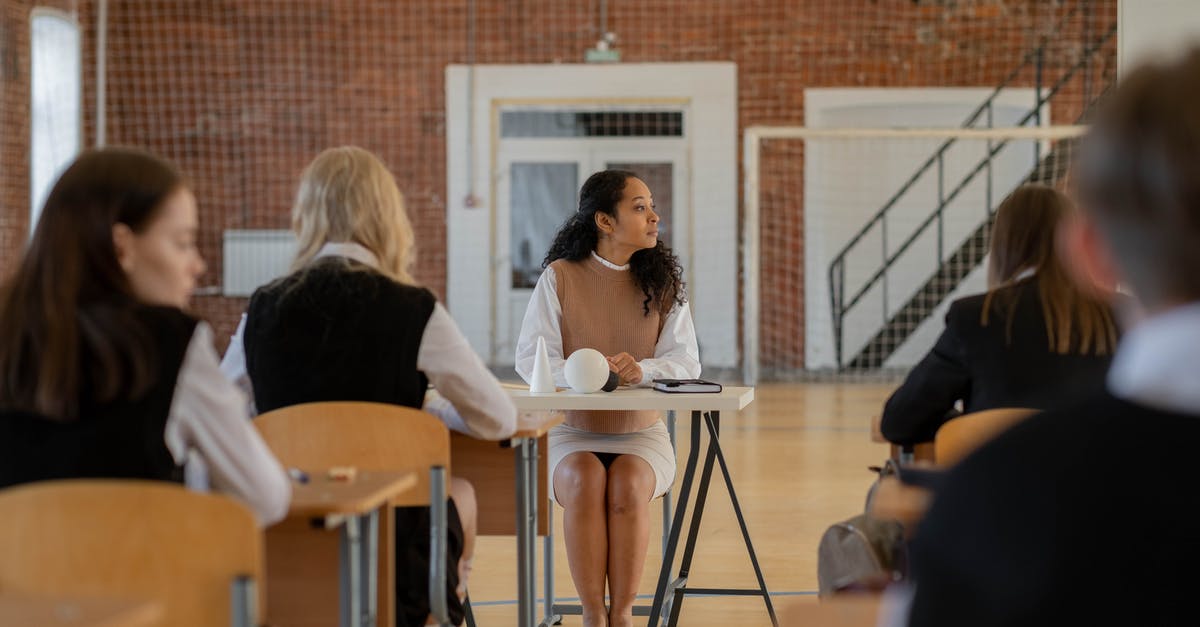 Class Synergies in Grand Kingdom - Woman in White Long Sleeve Shirt Sitting on Chair Class Synergies in Grand Kingdom - Woman in White Long Sleeve Shirt Sitting on Chair