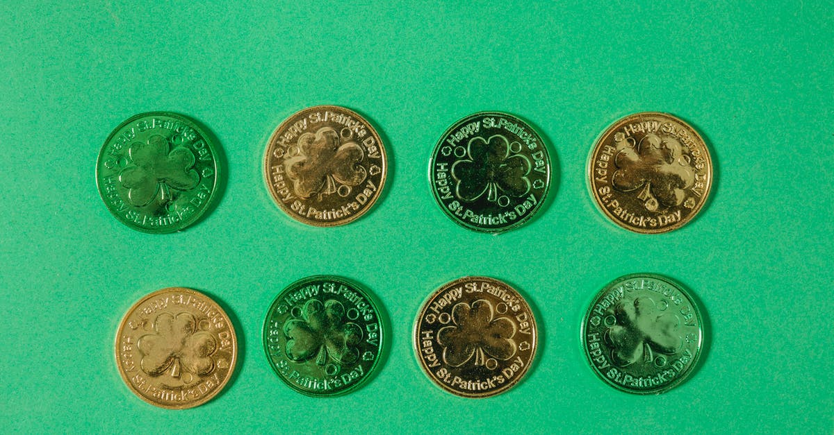 Coin changes to 3-leaf clover after playing sometime - Top view of gold coins with clover pattern arranged in rows on light green surface