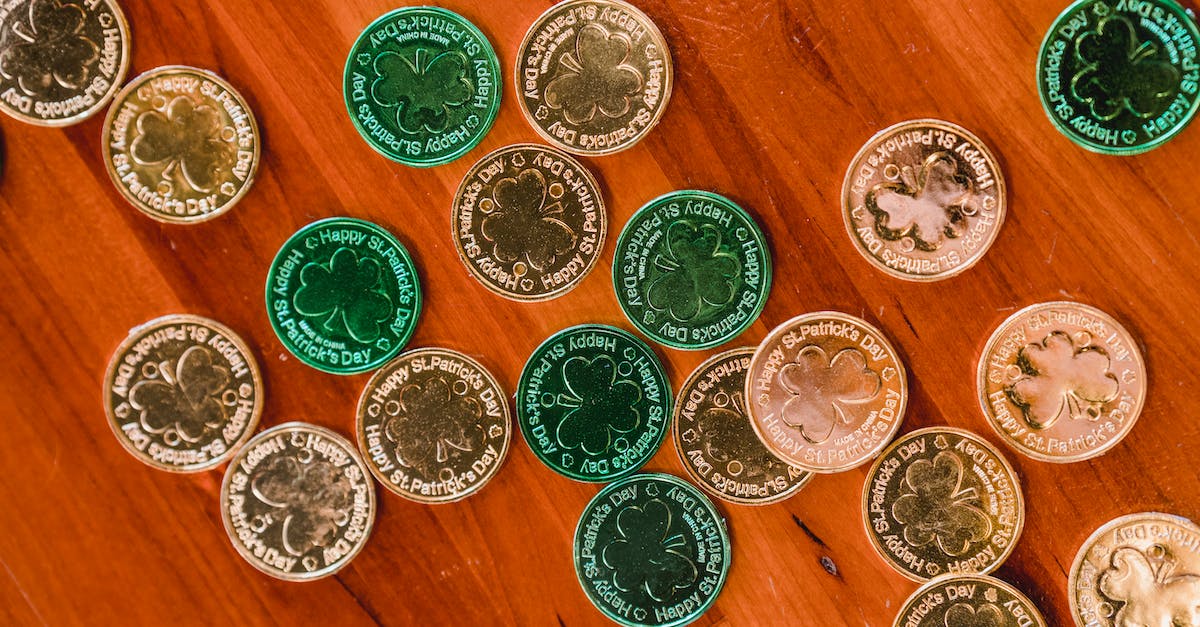 Coin changes to 3-leaf clover after playing sometime - Golden and green St Patricks day coins on wooden floor
