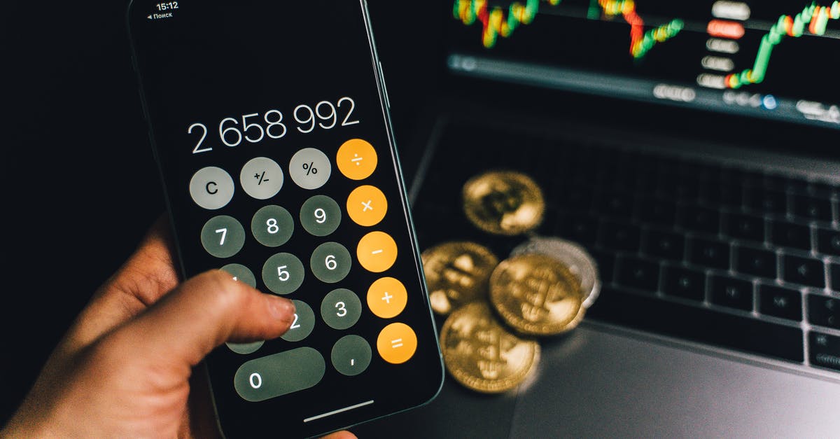 Coins displaying as popsicles? - A Person Holding a Smartphone with a Calculator App on the Screen Coins displaying as popsicles? - A Person Holding a Smartphone with a Calculator App on the Screen