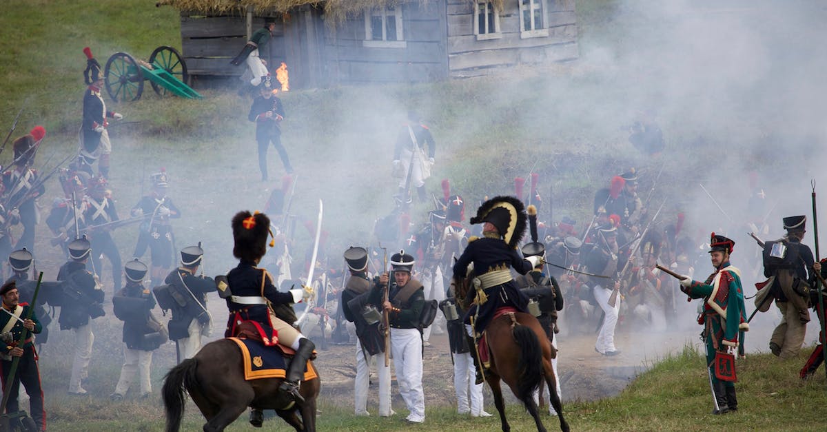 Command availability with multiple officers on base defense - Horse mounted officers and soldiers with rifles and muskets fighting on field in countryside during reenactment of Napoleonic war Command availability with multiple officers on base defense - Horse mounted officers and soldiers with rifles and muskets fighting on field in countryside during reenactment of Napoleonic war