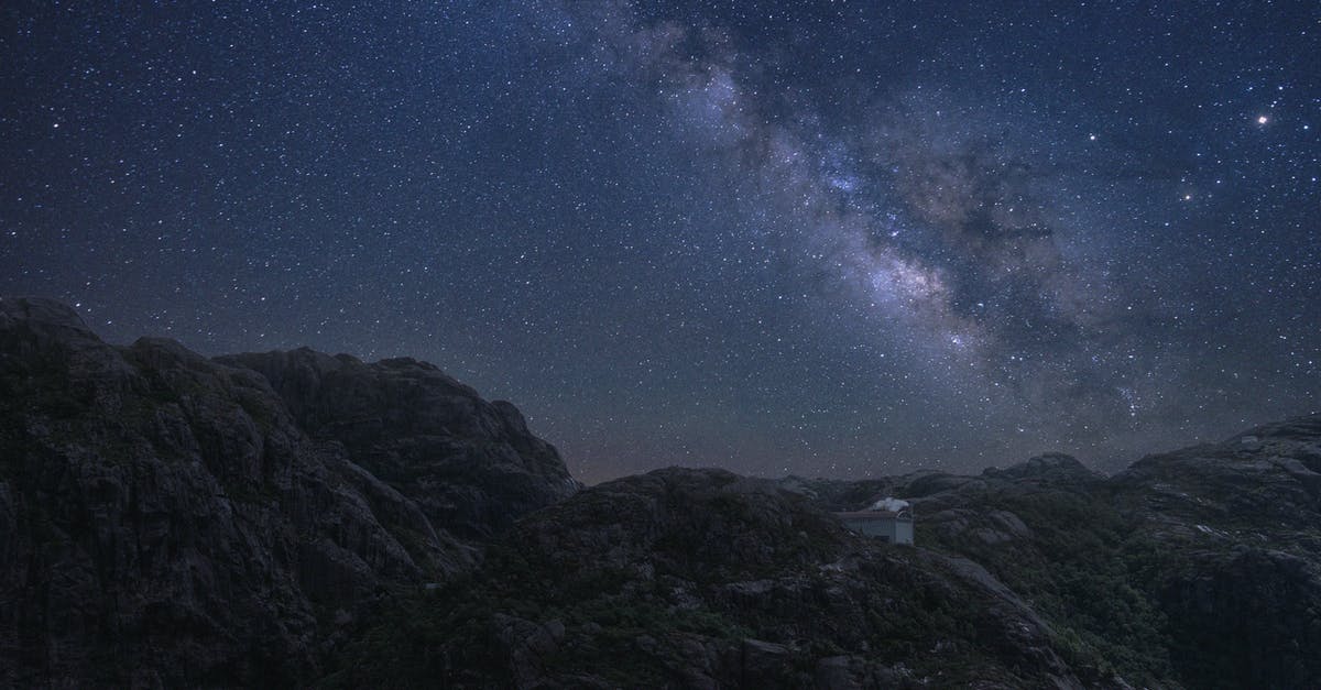 Command Block Effectiveness Range - Bright glowing stars shining over dark night sky in high rocky mountainous terrain