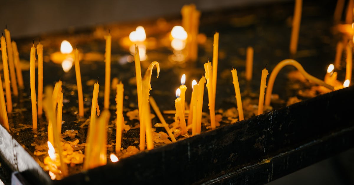 Commander Caius isn't there for the tasting ceremony during dampened spirits - Glowing candles in holy place of church