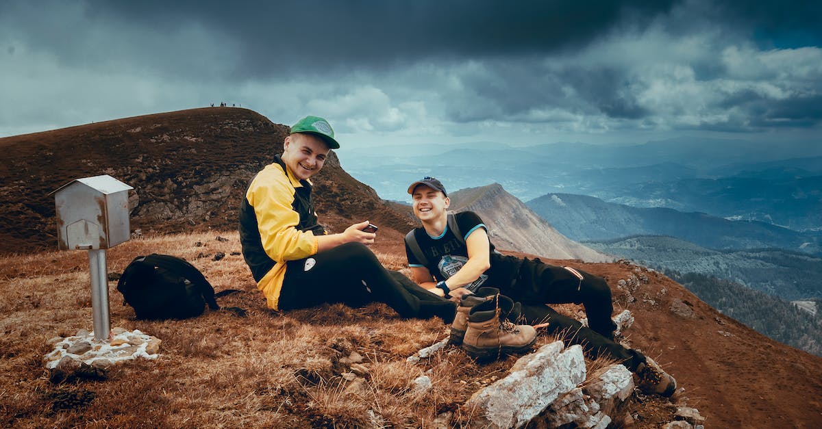 Companions or Adventurers - Men Sitting on Top of the Mountain
