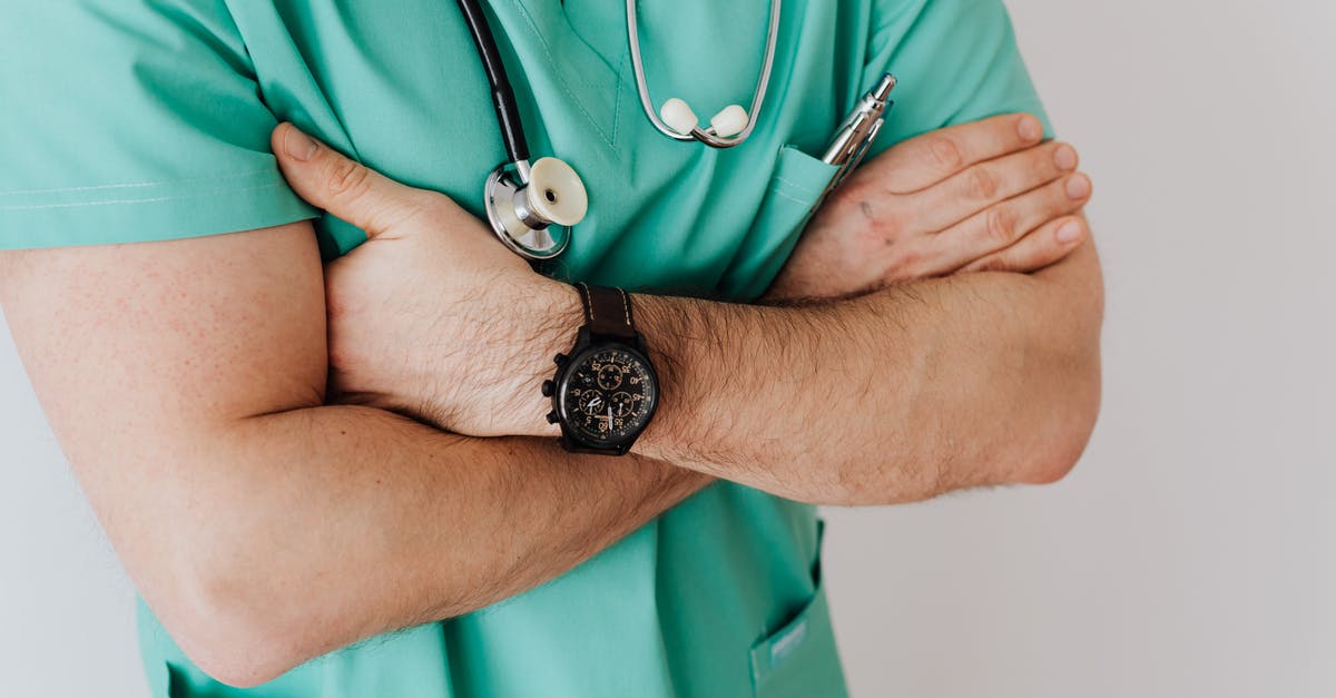 Configuring QuiverBow's Arms Assistant - Unrecognizable crop man in wristwatch with stethoscope Configuring QuiverBow's Arms Assistant - Unrecognizable crop man in wristwatch with stethoscope