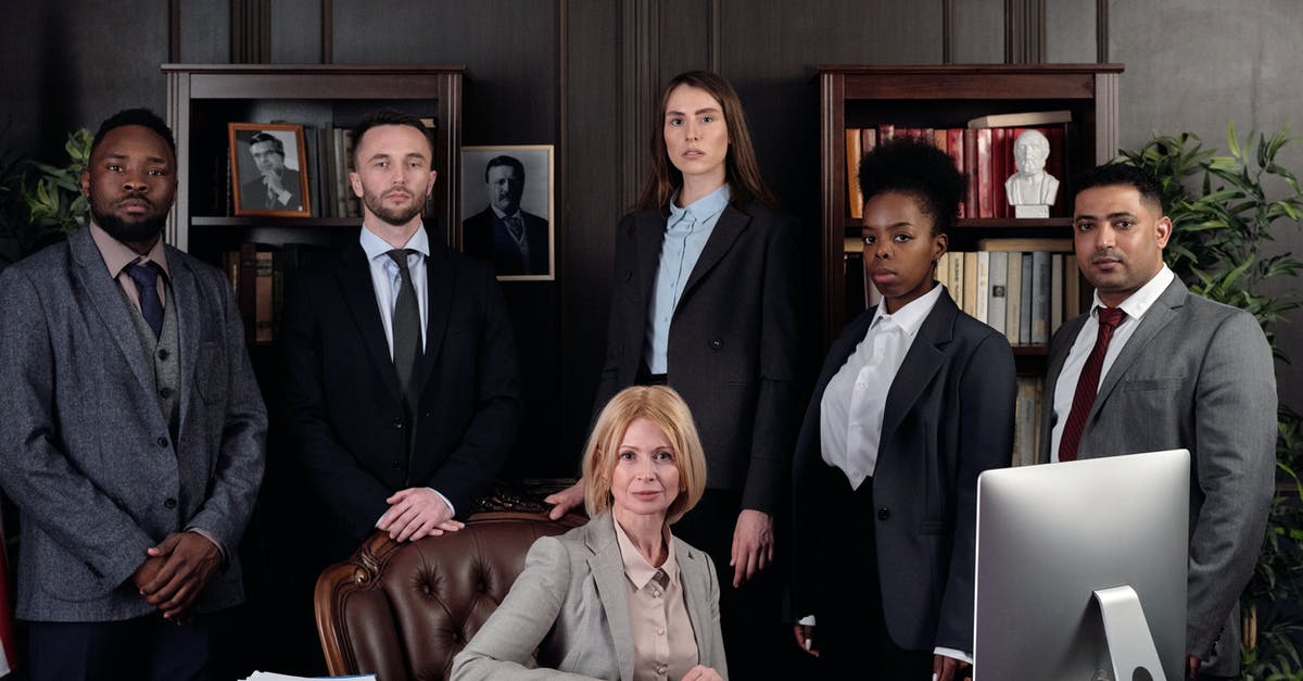 Conflicting Succession Law Conditions - Lawyers Posing for a Photo Conflicting Succession Law Conditions - Lawyers Posing for a Photo