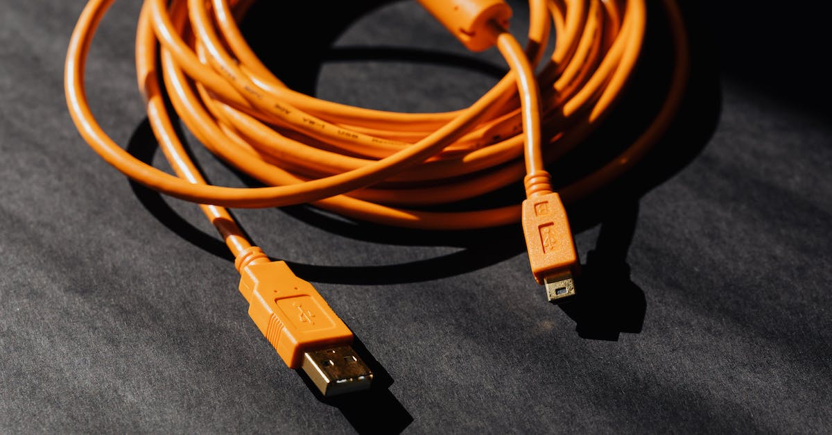 Connect to PC server from PlayStation minecraft [duplicate] - From above of orange usb to micro usb cable twisted into ring placed on black board