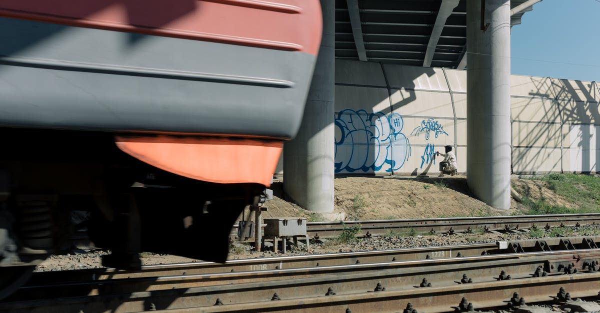 Connect two close parallel train tracks in factorio? - Close-Up Shot of Railway under the Bridge