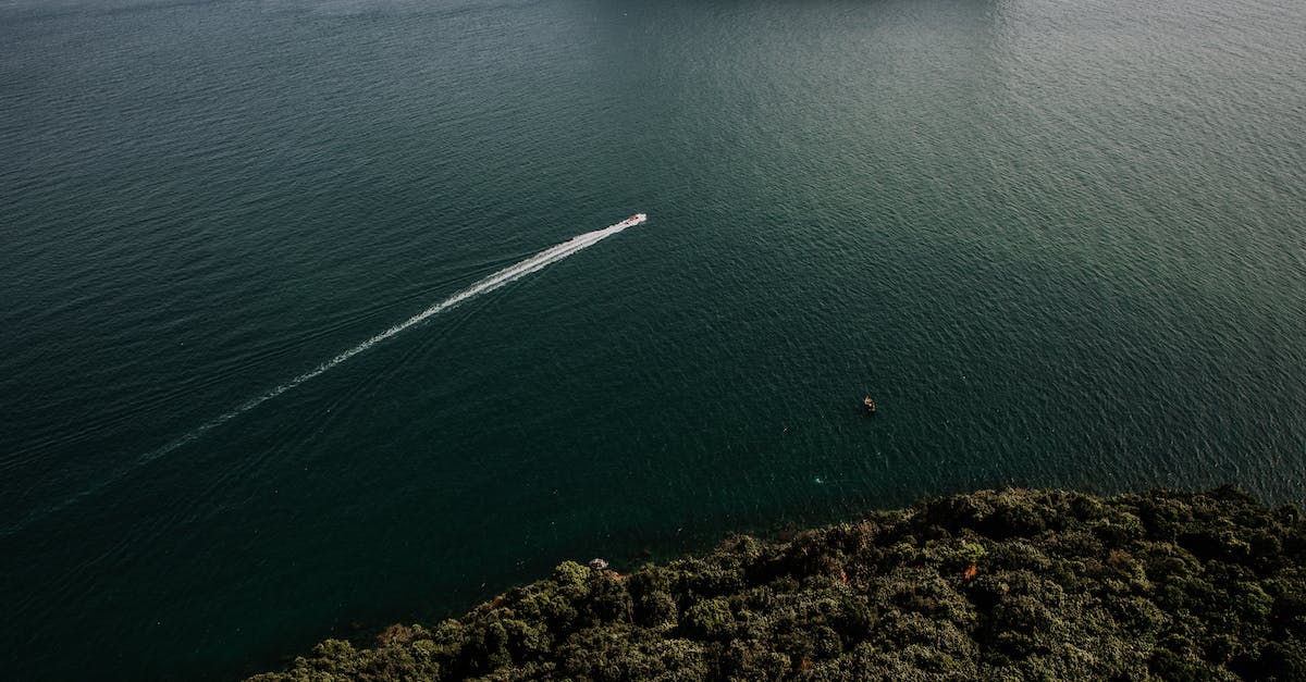 Contested Territory on iOS Bloons City - White Boat on Sea Near Green Island