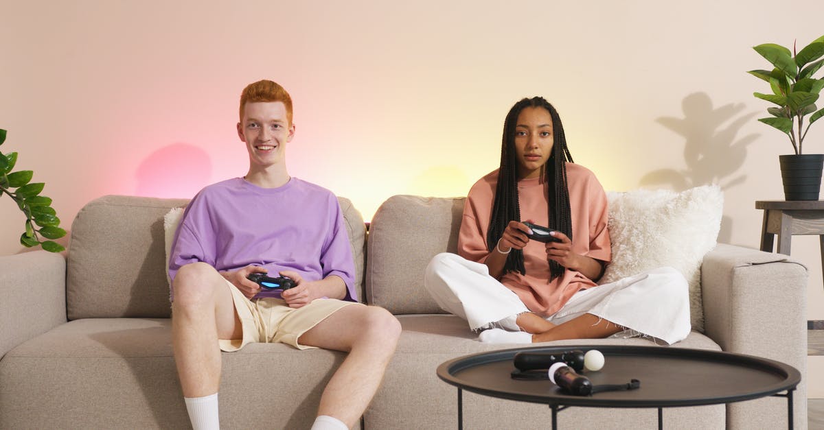Controllers disconnecting from console - A Couple Playing a Video Game while Sitting on the Couch