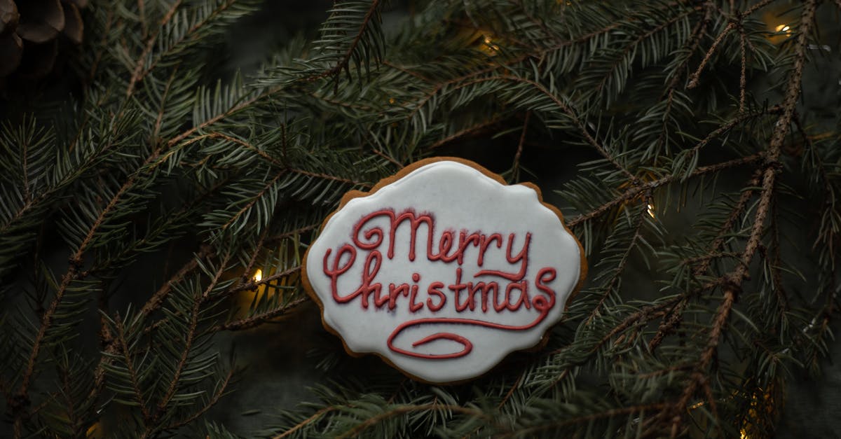 Cookie Clicker- [Last chance to see] and [All natural sugar cane] shadow achievements - From above of delicious biscuit with decorative title on sugar glaze between coniferous tree sprigs with garland on Christmas Day