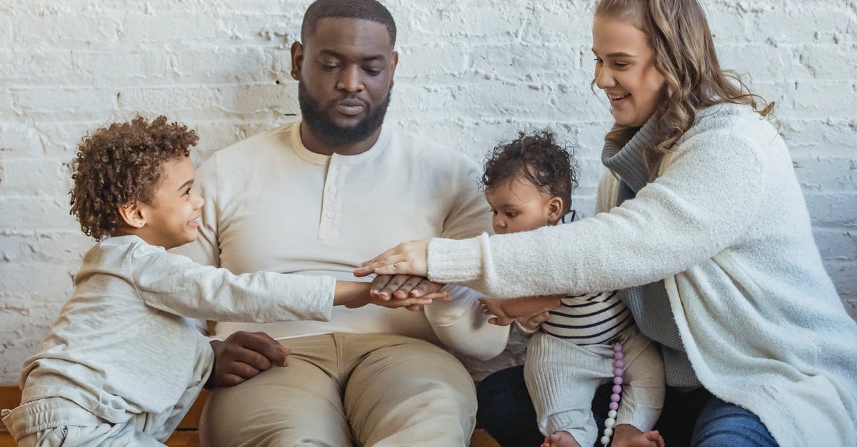 Could a member of my family and I play a game in Steam at the same time? [duplicate] - Positive multiracial parents playing game with adorable black boy and toddler while sitting on floor near wall in light room