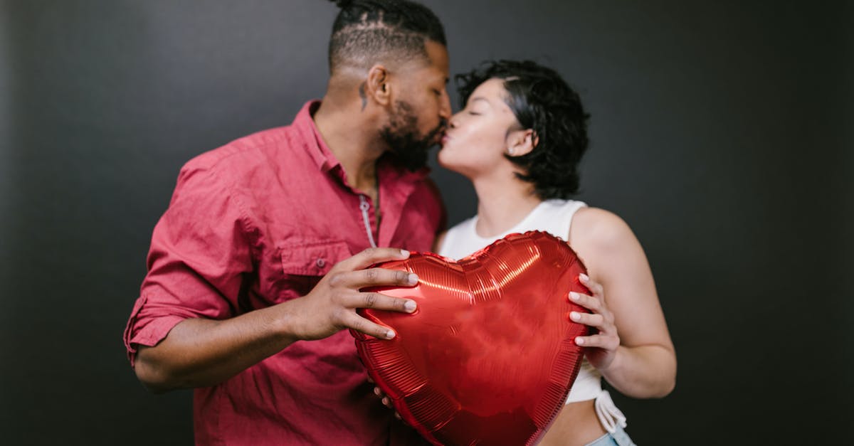 Could Sha'ira romance affect my chances with Liara? - Couple Kissing While Holding a Red Heart Shaped Balloon Could Sha'ira romance affect my chances with Liara? - Couple Kissing While Holding a Red Heart Shaped Balloon