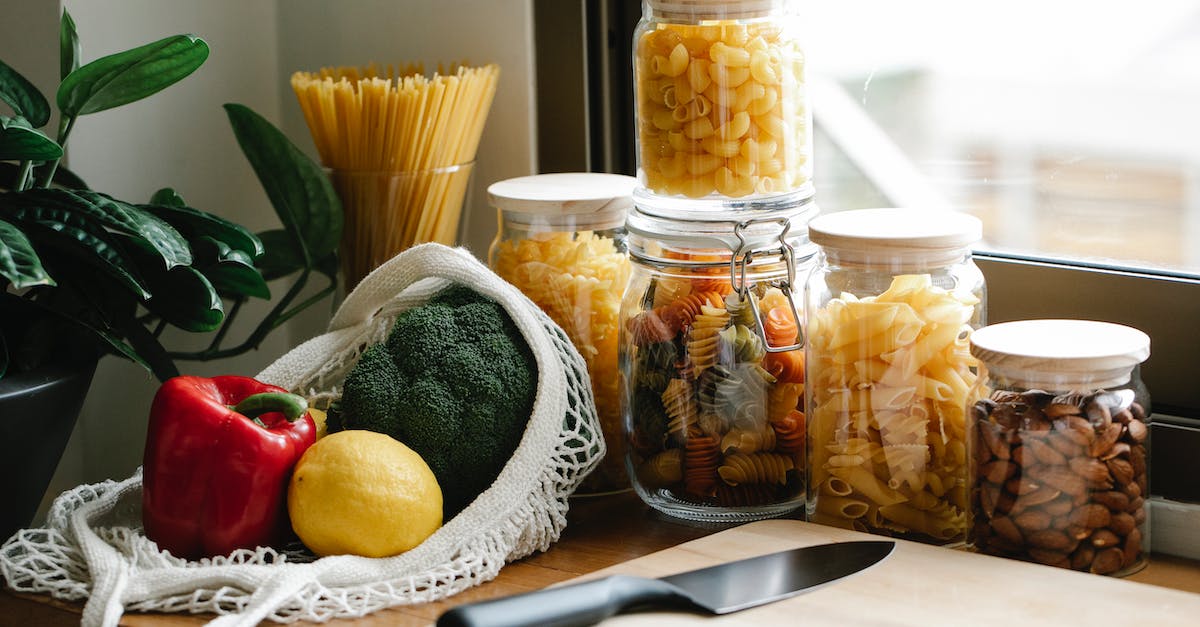 Counter Counter Knife - Punch Stab - Assorted vegetables placed on counter near jars with pasta