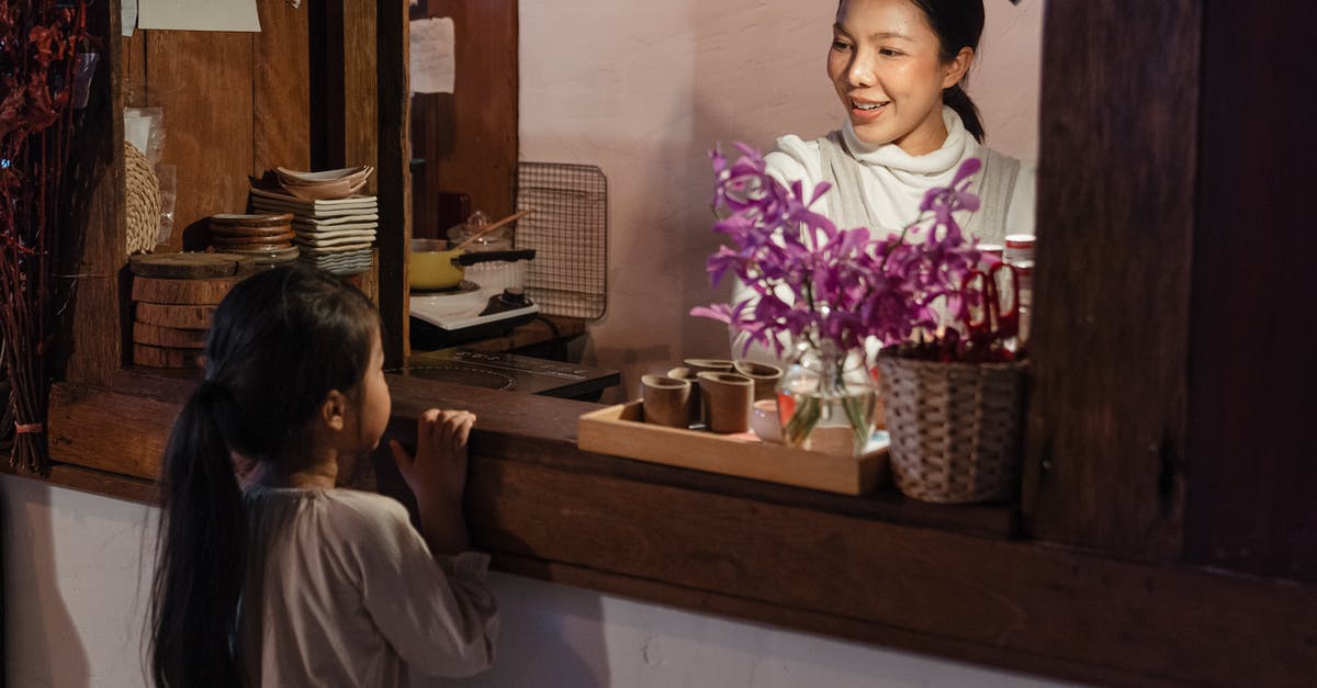 Counter Little Mac KO Punch - Cheerful adult ethnic female worker talking with cute girl in cafe Counter Little Mac KO Punch - Cheerful adult ethnic female worker talking with cute girl in cafe