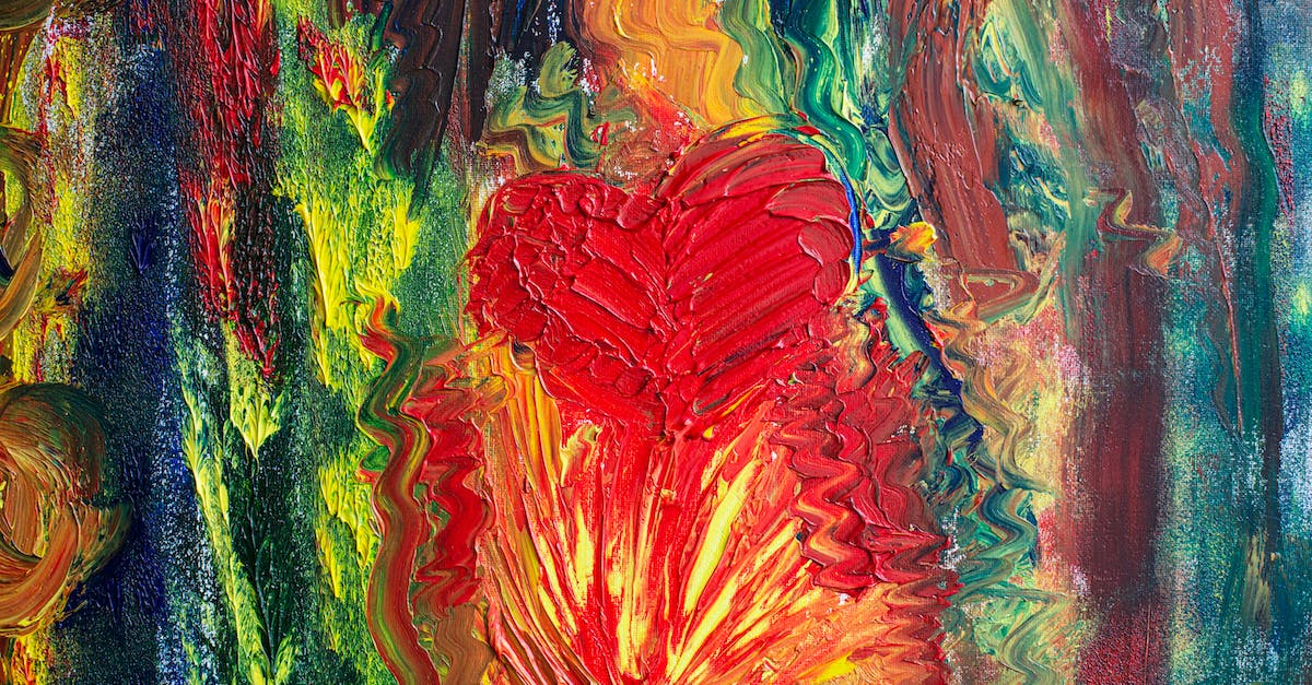 Create more hearts? - Abstract strokes of multicolored paints randomly smeared on bright surface with red heart shaped drawing in modern studio with art works Create more hearts? - Abstract strokes of multicolored paints randomly smeared on bright surface with red heart shaped drawing in modern studio with art works