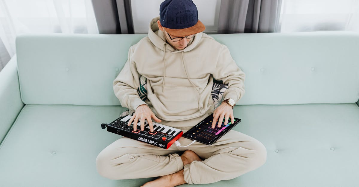 Creating Builds in Dota 2 - Man Creating Music on Pad and Keyboard