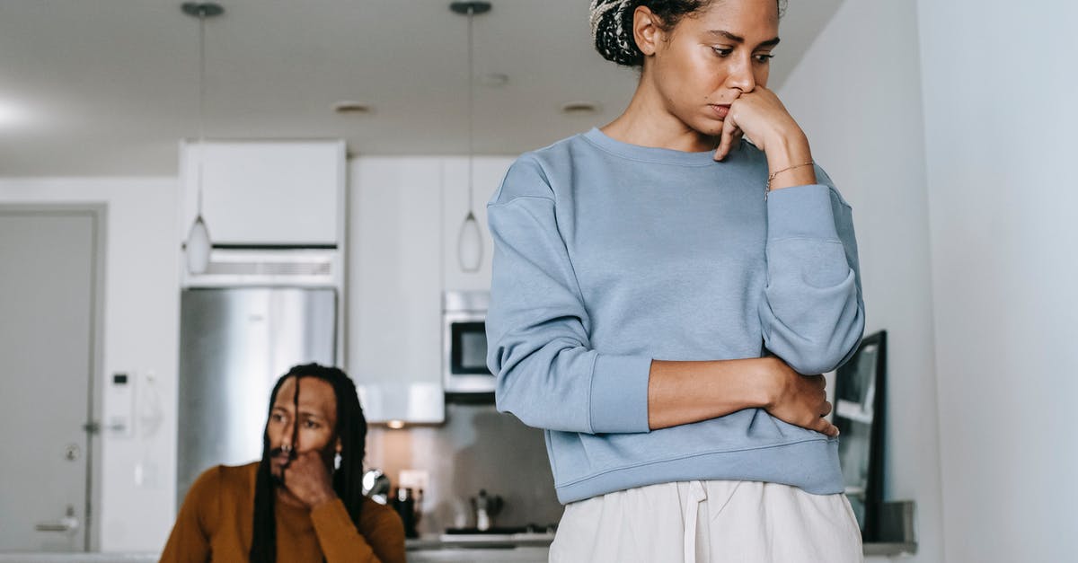 CSGO Low FPS Issue - From below of young displeased African American female touching face near pensive boyfriend during conflict in kitchen CSGO Low FPS Issue - From below of young displeased African American female touching face near pensive boyfriend during conflict in kitchen