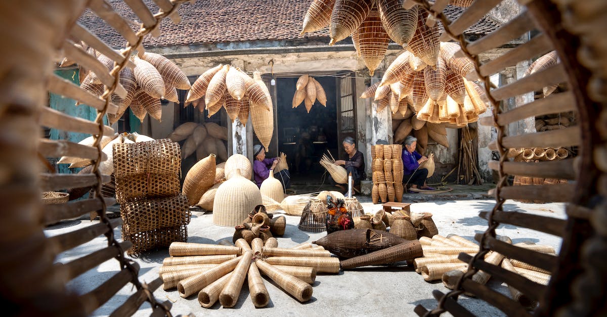 Culture building destroyed (not disabled) if I build one as different culture? - Senior ethnic women near shabby residential building and many different timber fish traps in daylight