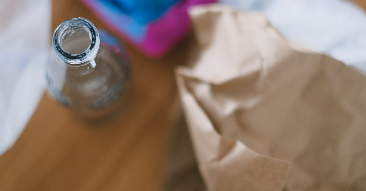 Cursed earth from extra utilities does not spawn mobs - Top view of empty glass bottle with creased paper and egg container prepared for recycling