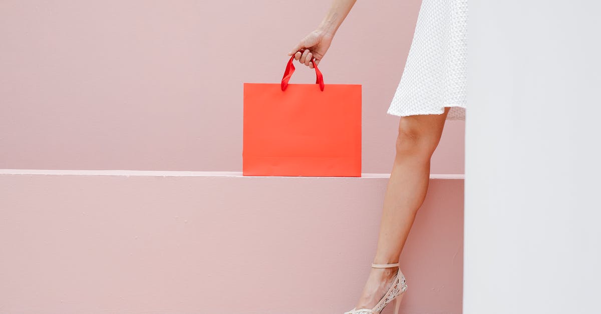 Custom armor stand name with multiple lines - Crop anonymous stylish female in white dress and high heels carrying red shopping bag against pink wall