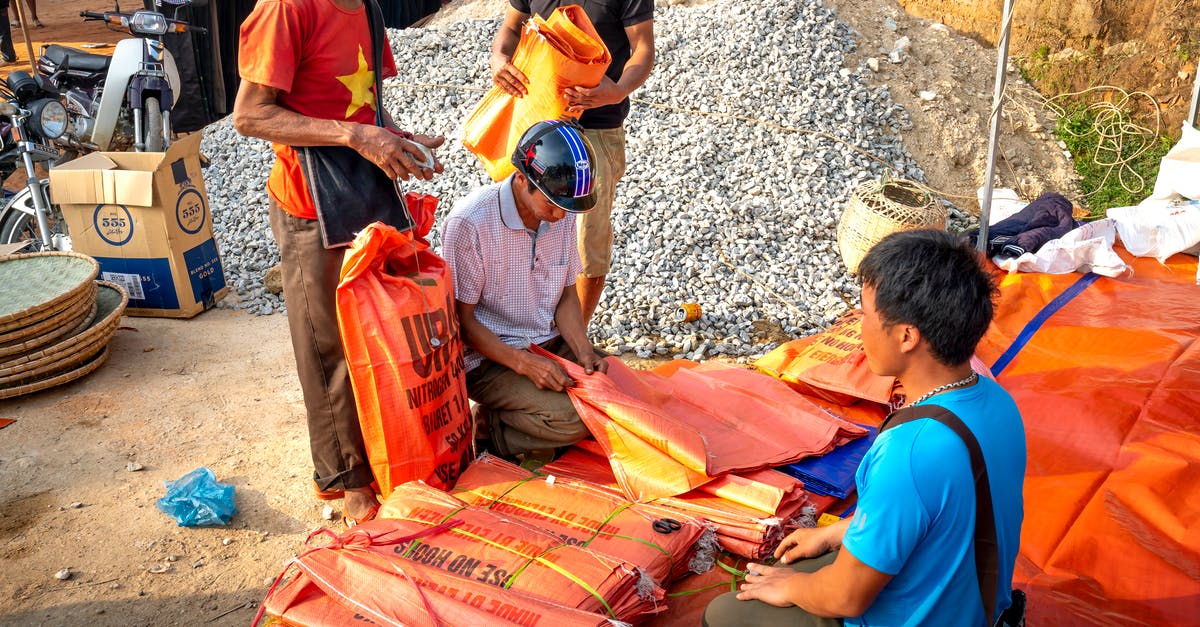 Custom Villager with potions as trade - Asian men buying plastic bags in local street market Custom Villager with potions as trade - Asian men buying plastic bags in local street market