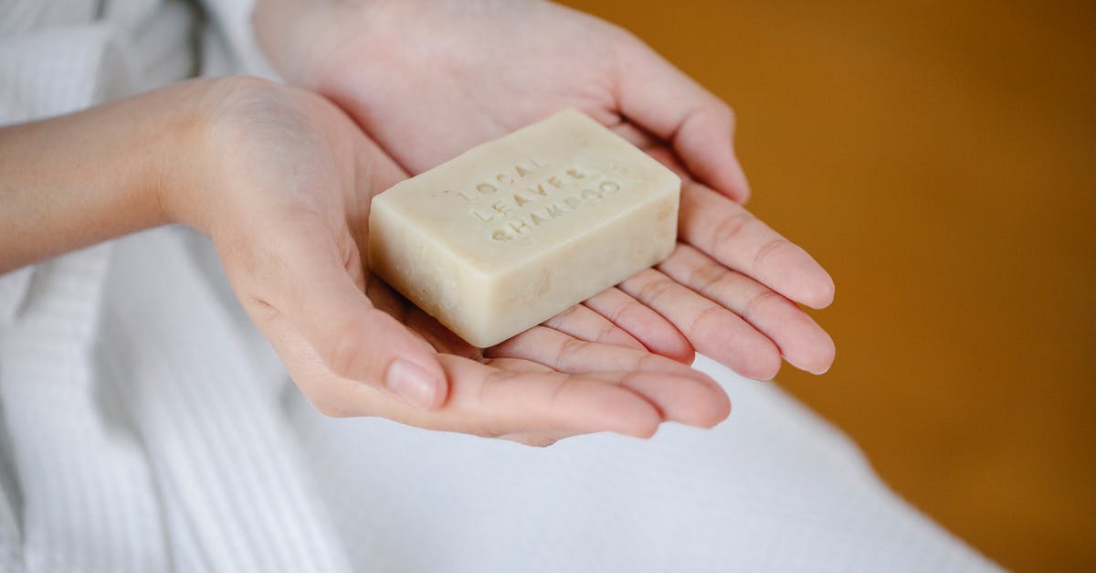 Daily challenge not showing - Crop anonymous female showing rectangular shaped dry ecological shampoo with title on blurred background Daily challenge not showing - Crop anonymous female showing rectangular shaped dry ecological shampoo with title on blurred background
