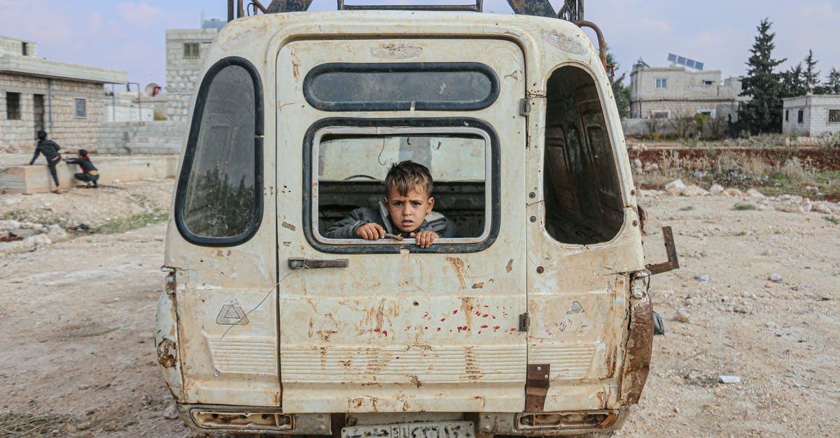 Damage mitigation in God of War series - Boy sitting in broken car Damage mitigation in God of War series - Boy sitting in broken car