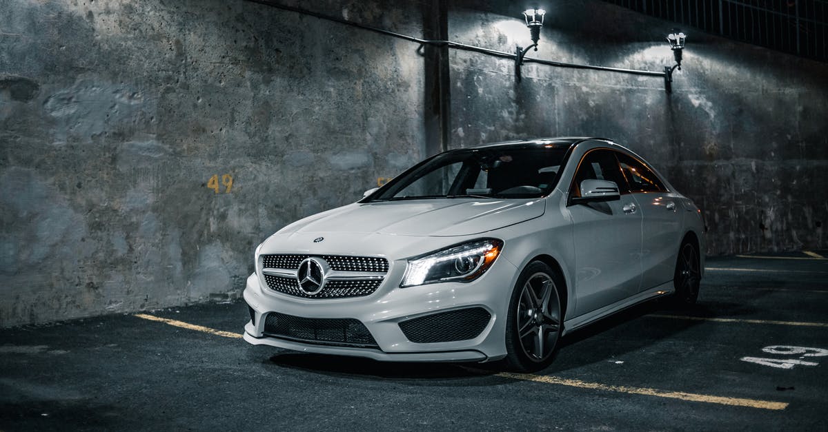 Damage numbers for all weapons - Luxury white tuned sports car with turned headlights parked next to tall gray shabby wall at night in light of lamps Damage numbers for all weapons - Luxury white tuned sports car with turned headlights parked next to tall gray shabby wall at night in light of lamps