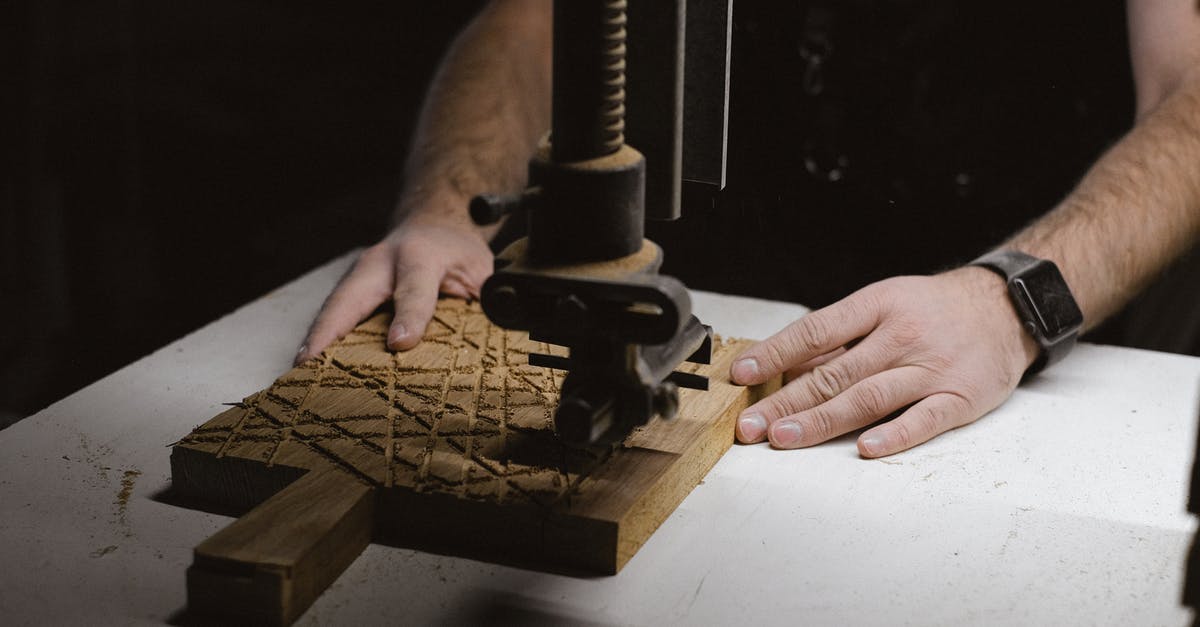 Dark Souls 3: Special ability / parry (L2 on ps4) sometimes triggers unintentionally. Why? - Unrecognizable male carpenter using special metal instrument to carve wooden board while working at workbench on black background in dark workshop