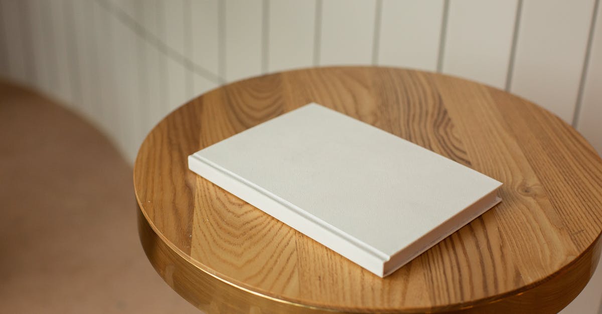 Dead or Alive 5 Last Round - Character and Story Unlocking - From above of round shaped wooden table with blank white book on blurred background Dead or Alive 5 Last Round - Character and Story Unlocking - From above of round shaped wooden table with blank white book on blurred background