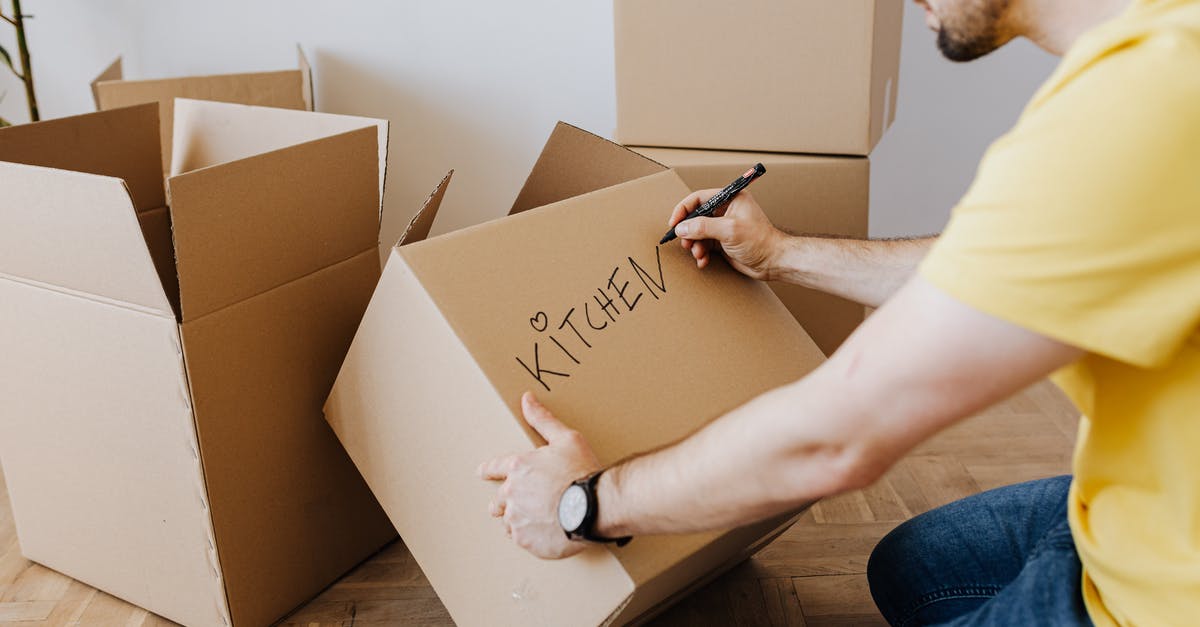 Death Stranding Doesn't Open - Crop man with pile of cardboard boxes for packing belongings