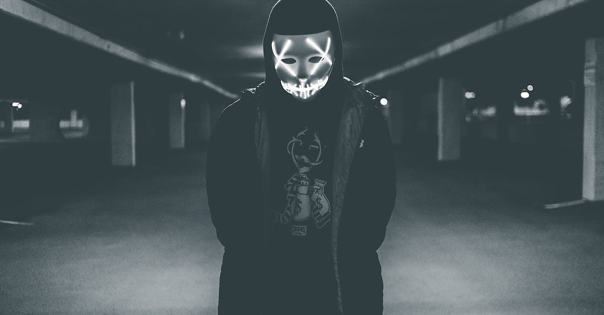 Demon Fusion in SMT: Strange Journey - Man wearing hood and mask with neon lights