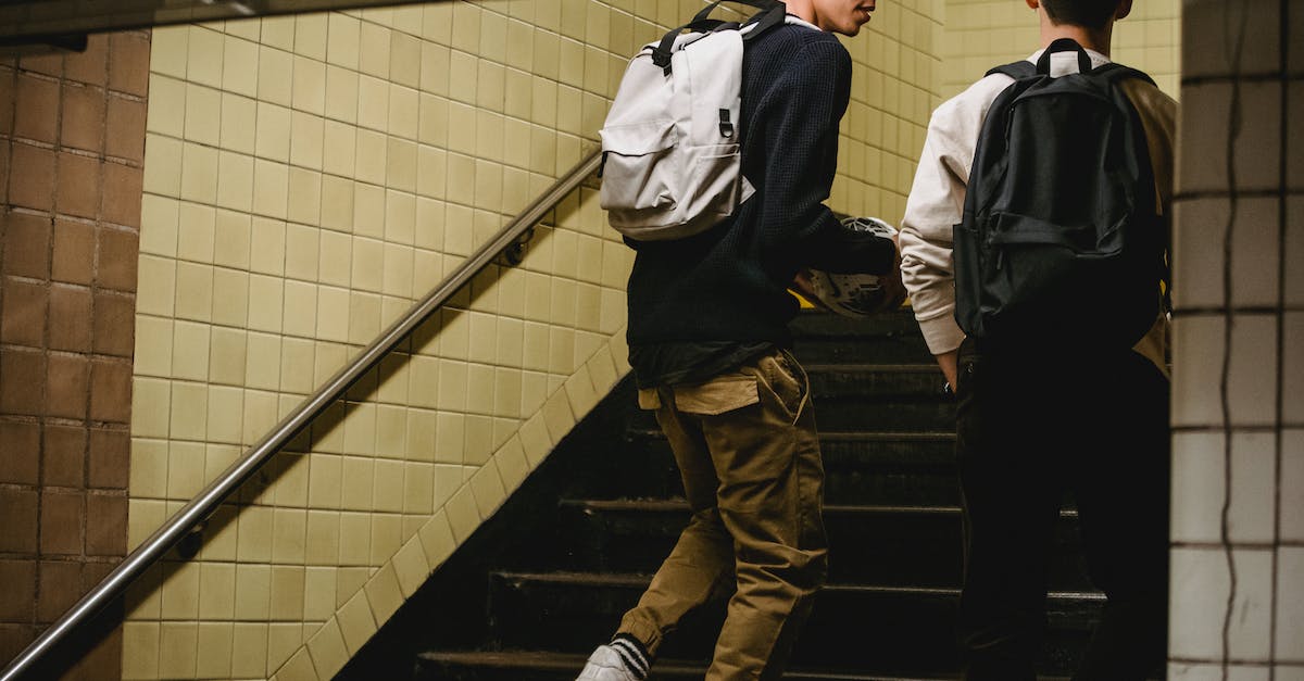 Destiny Chat Exit - Crop male friends going upstairs in underground passage Destiny Chat Exit - Crop male friends going upstairs in underground passage