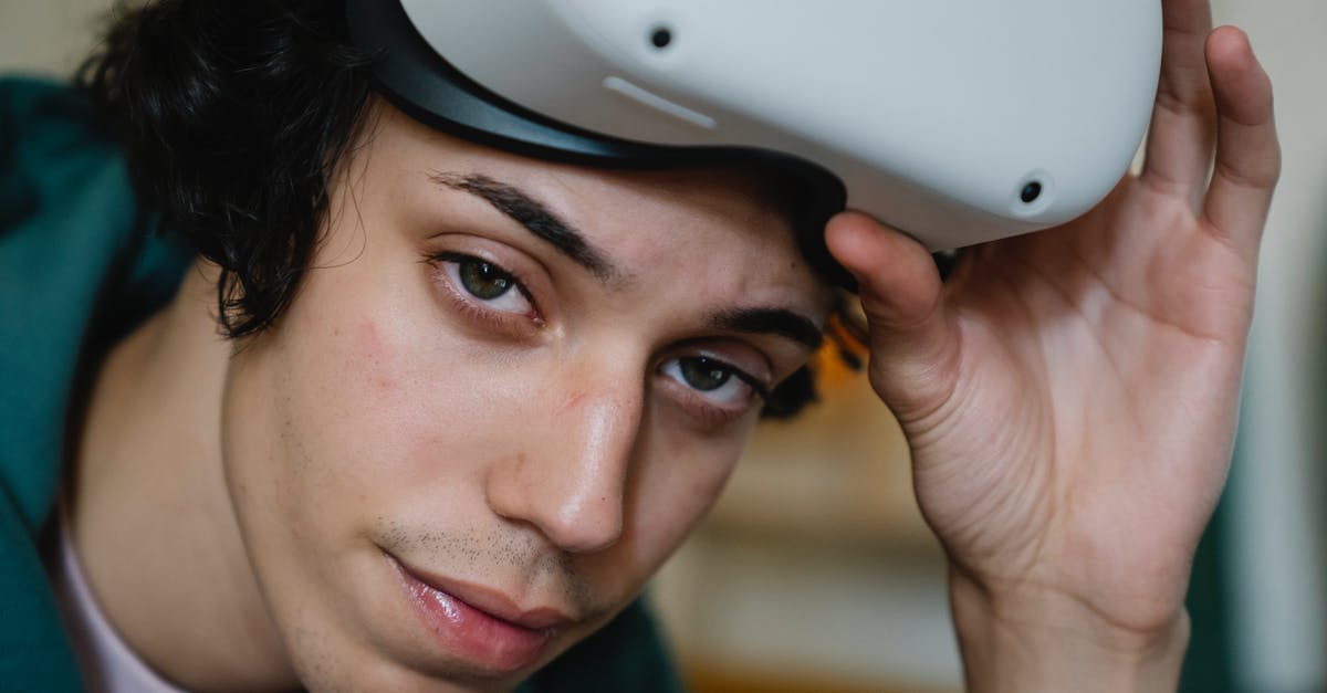 Detect which player ignites the TNT using flint and steel - Young male gamer wearing VR headset for exploring cyberspace and playing video games looking at camera Detect which player ignites the TNT using flint and steel - Young male gamer wearing VR headset for exploring cyberspace and playing video games looking at camera